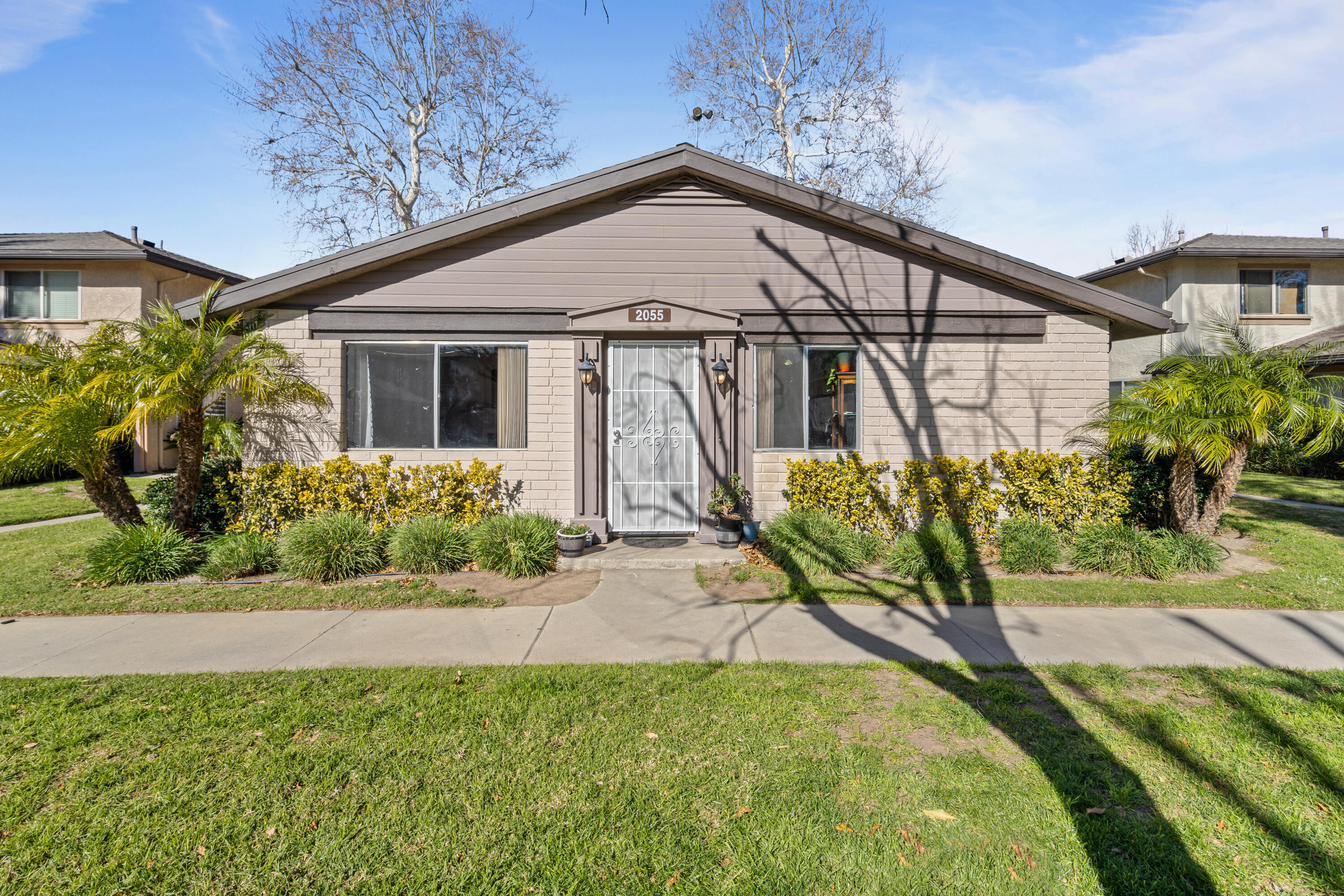 a front view of a house with garden
