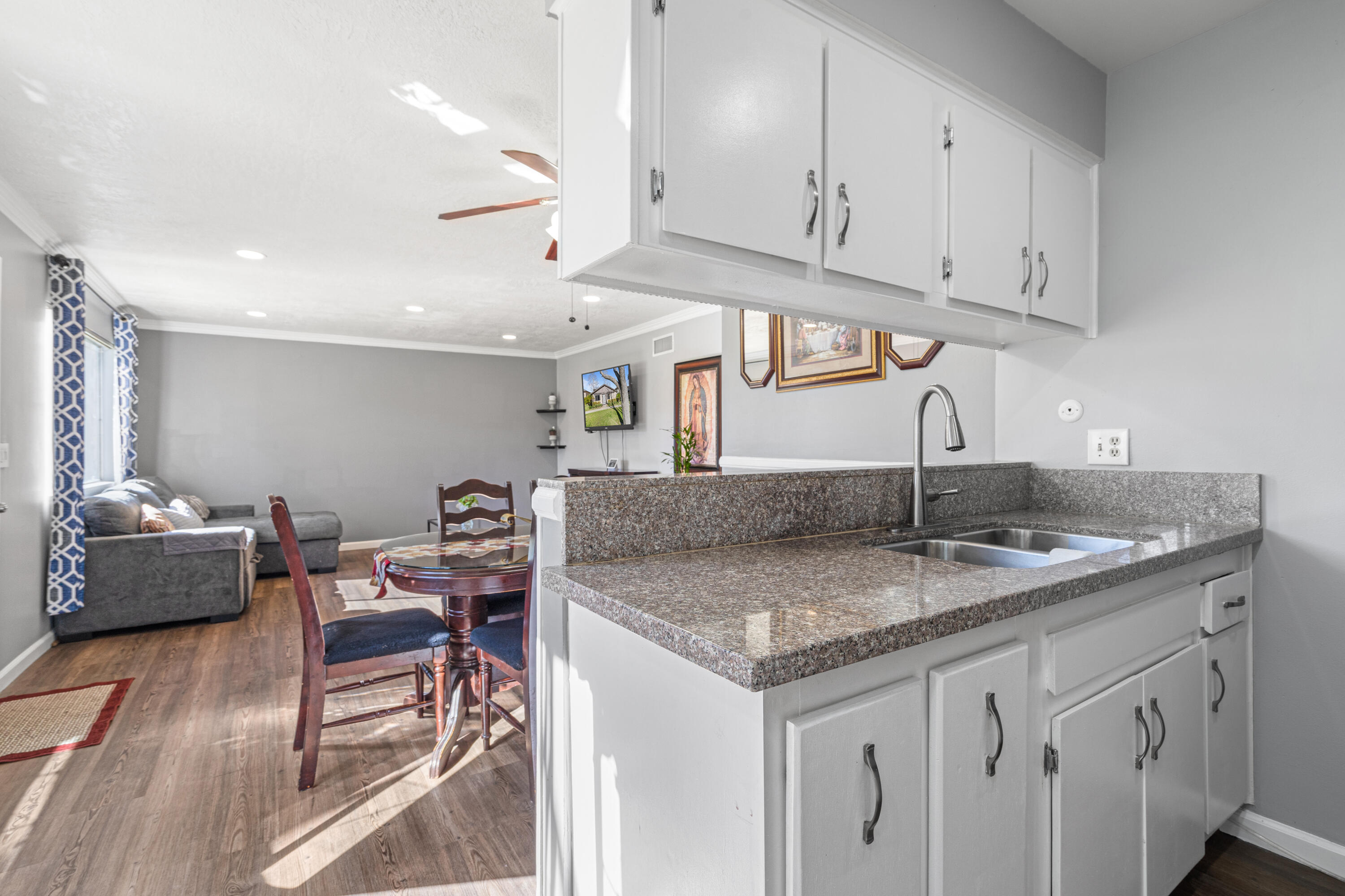 2055 Avenida Placida, Unit 1 Simi Valley, CA 93063 - Photo 14 of 39 a kitchen with stainless steel appliances granite countertop a sink dishwasher and cabinets with wooden floor