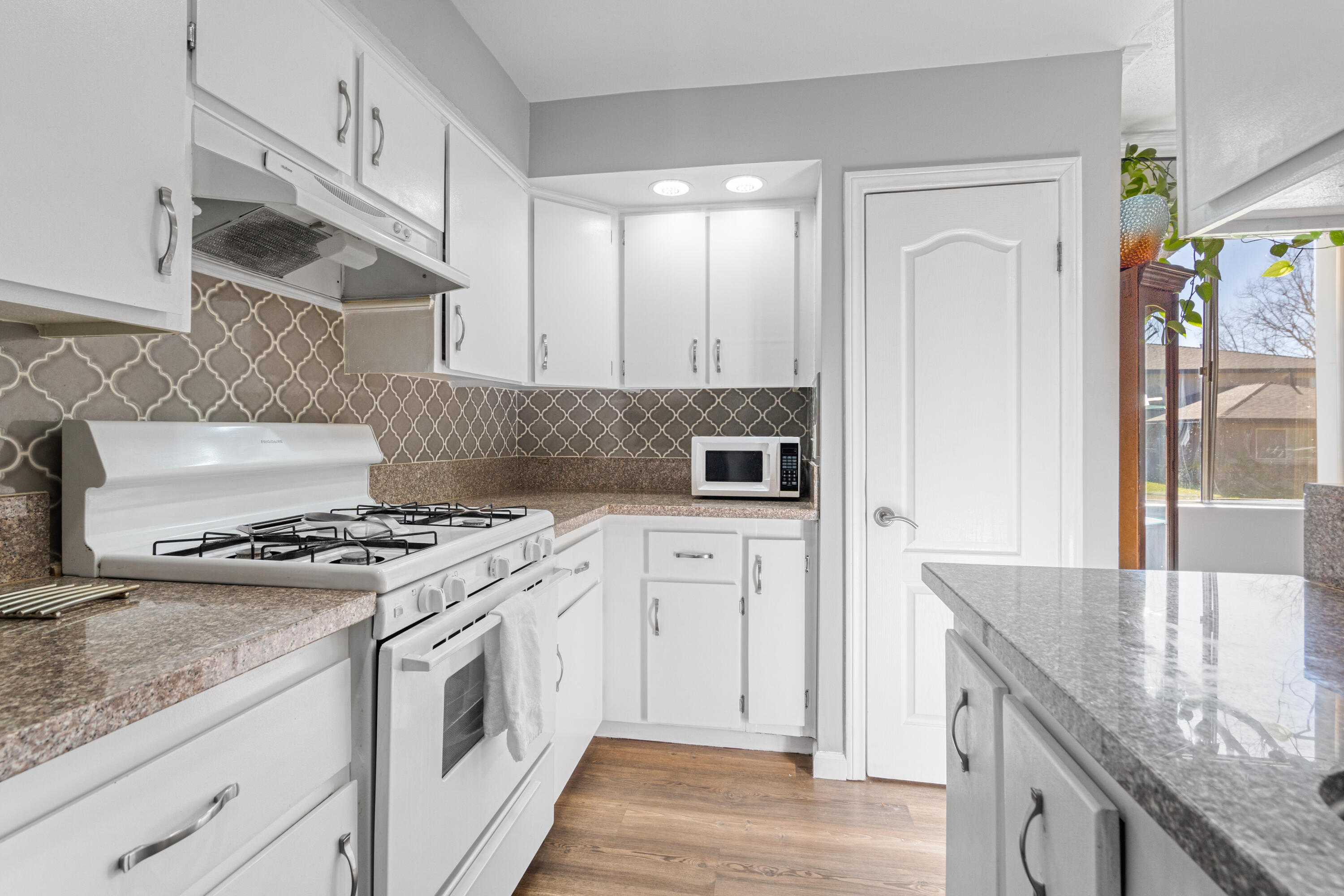 2055 Avenida Placida, Unit 1 Simi Valley, CA 93063 - Photo 15 of 39 a kitchen with stainless steel appliances granite countertop a stove and a sink