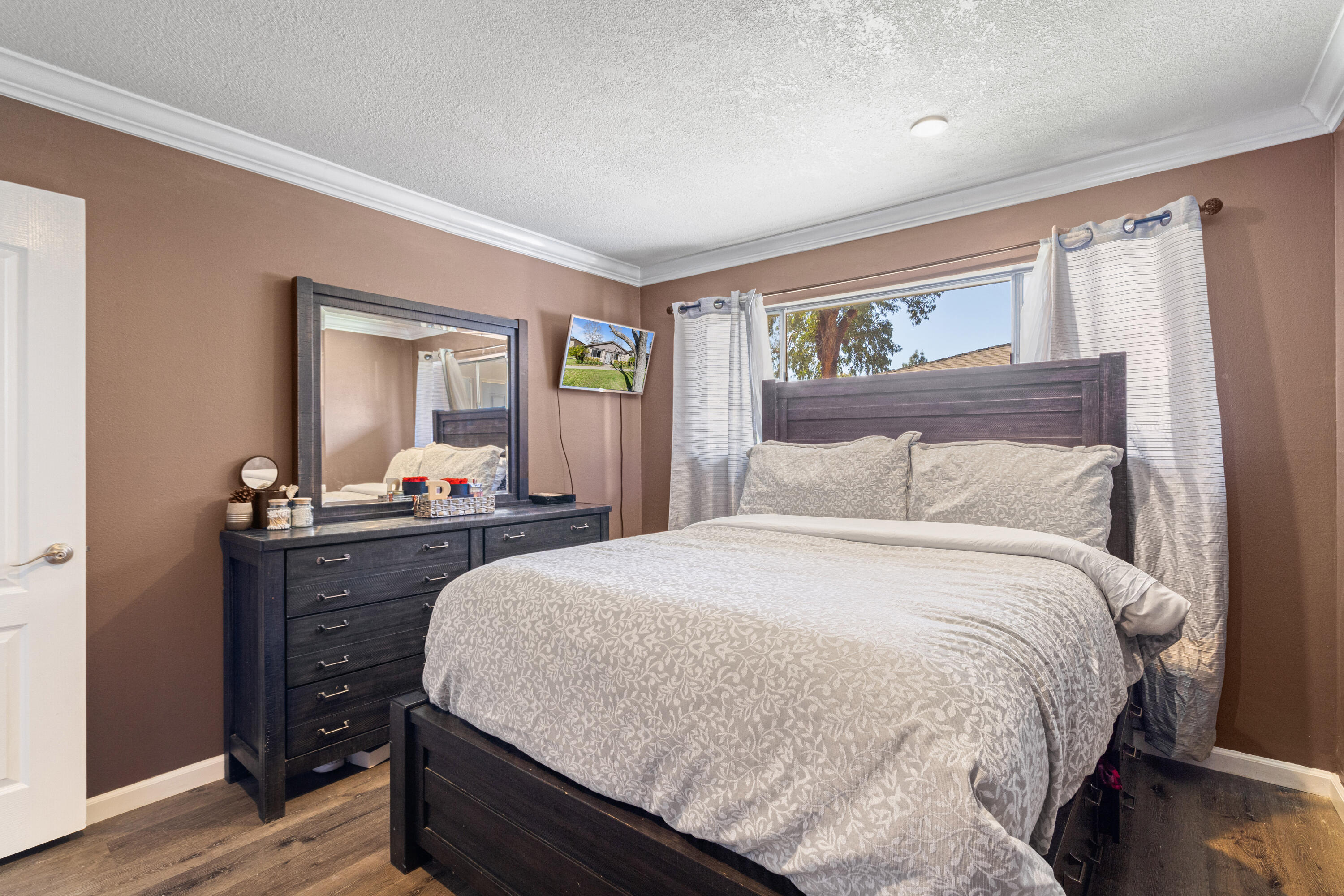 2055 Avenida Placida, Unit 1 Simi Valley, CA 93063 - Photo 16 of 39 a bedroom with a bed and wooden floor