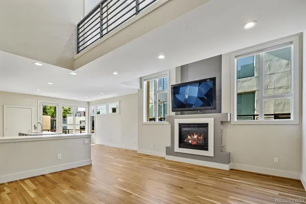 a living room with fireplace furniture and a flat screen tv