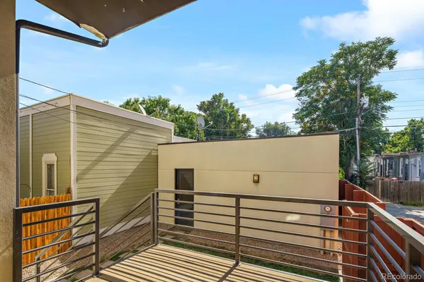 a view of a house with many windows and wooden fence