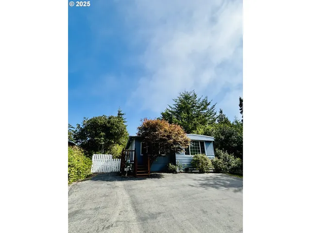 a view of a house with a small yard and a large window