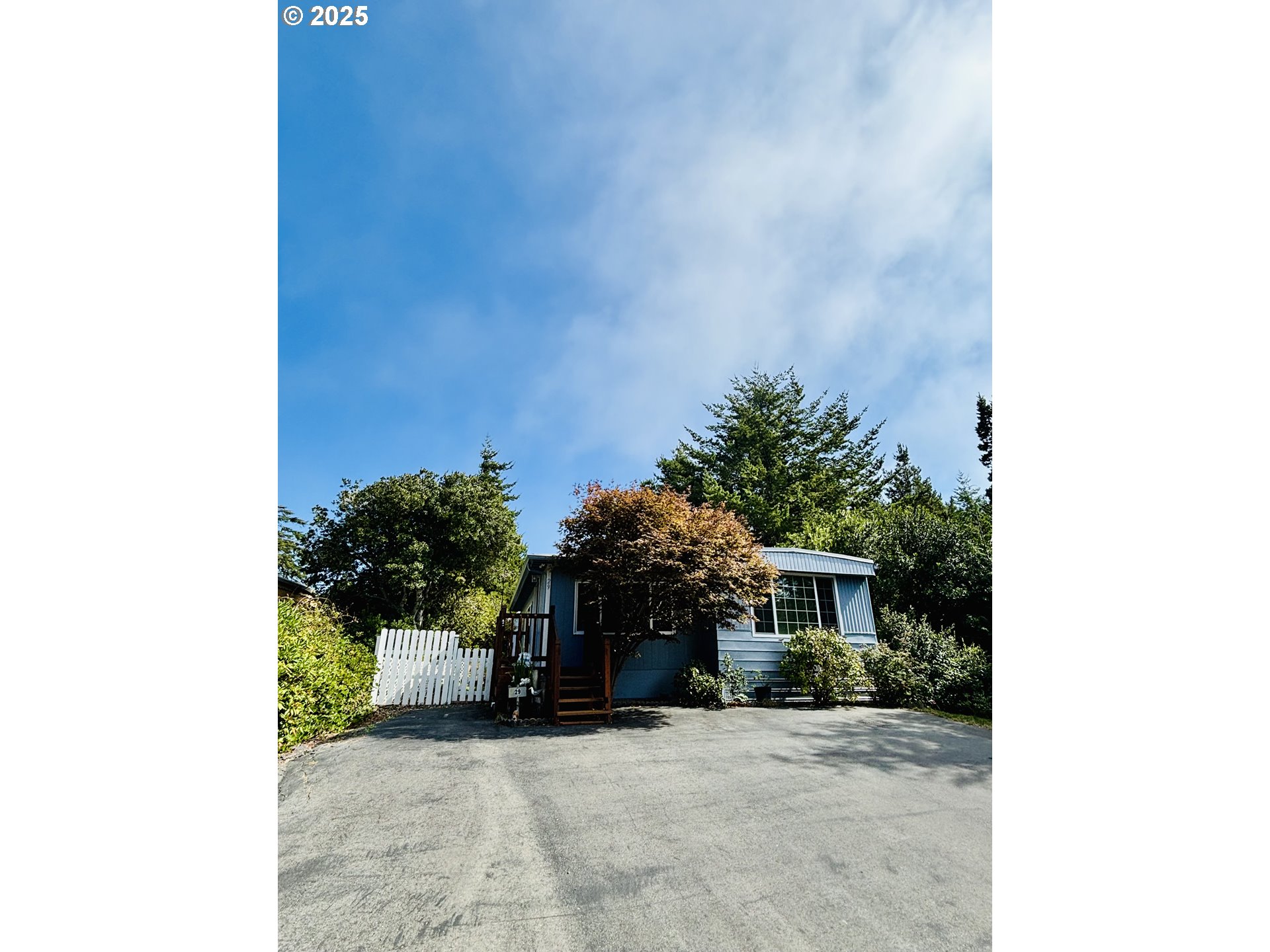 a view of a house with a small yard and a large window