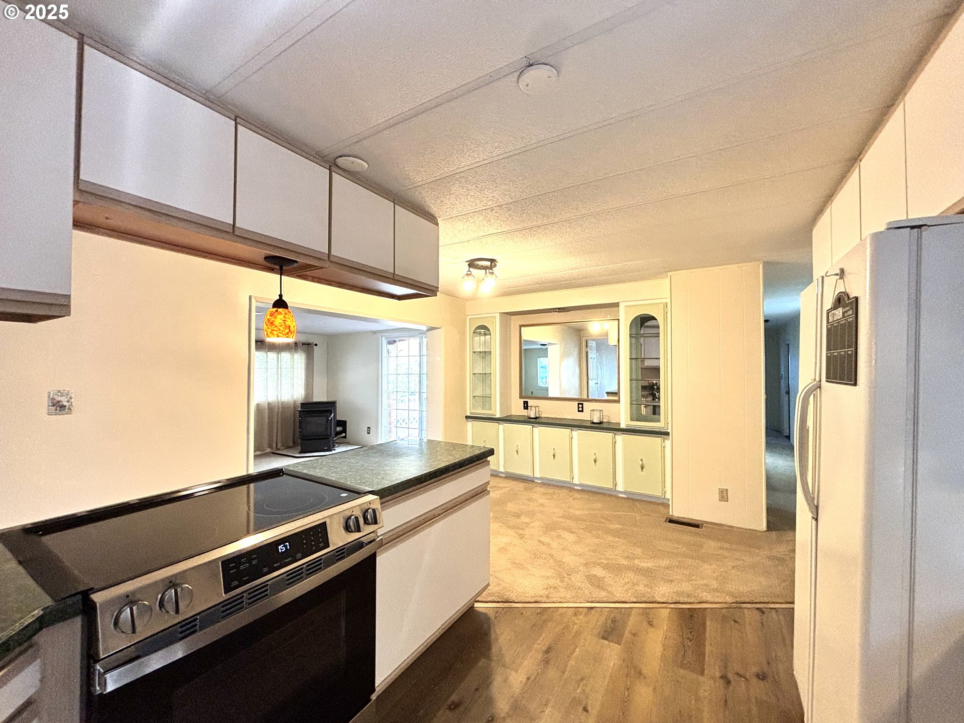 1600 Rhododendron Drive, Unit 29 Florence, OR 97439 - Photo 11 of 35 a large kitchen with stainless steel appliances granite countertop a refrigerator and a stove top oven