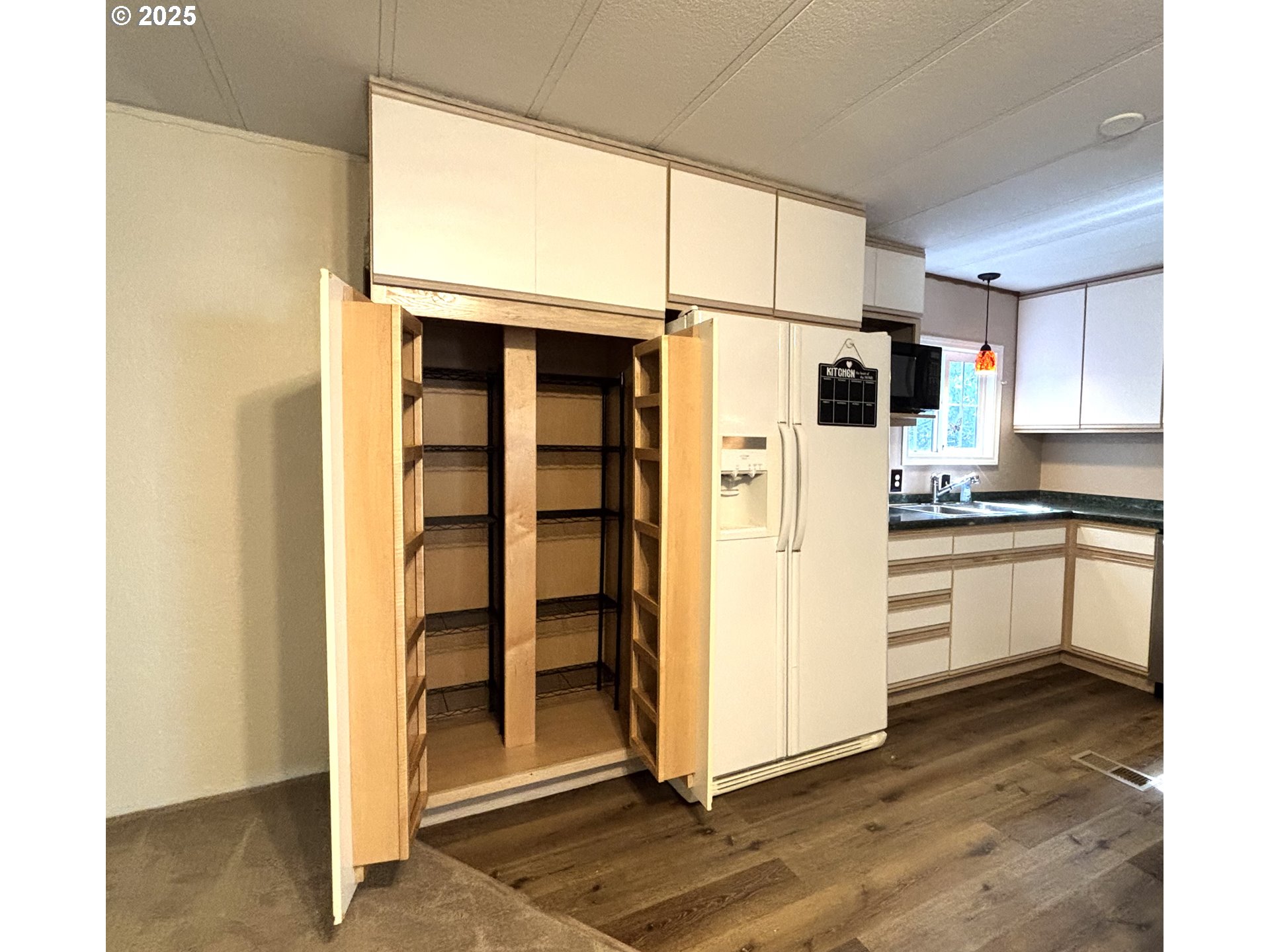 1600 Rhododendron Drive, Unit 29 Florence, OR 97439 - Photo 12 of 35 a kitchen with stainless steel appliances a refrigerator and cabinets