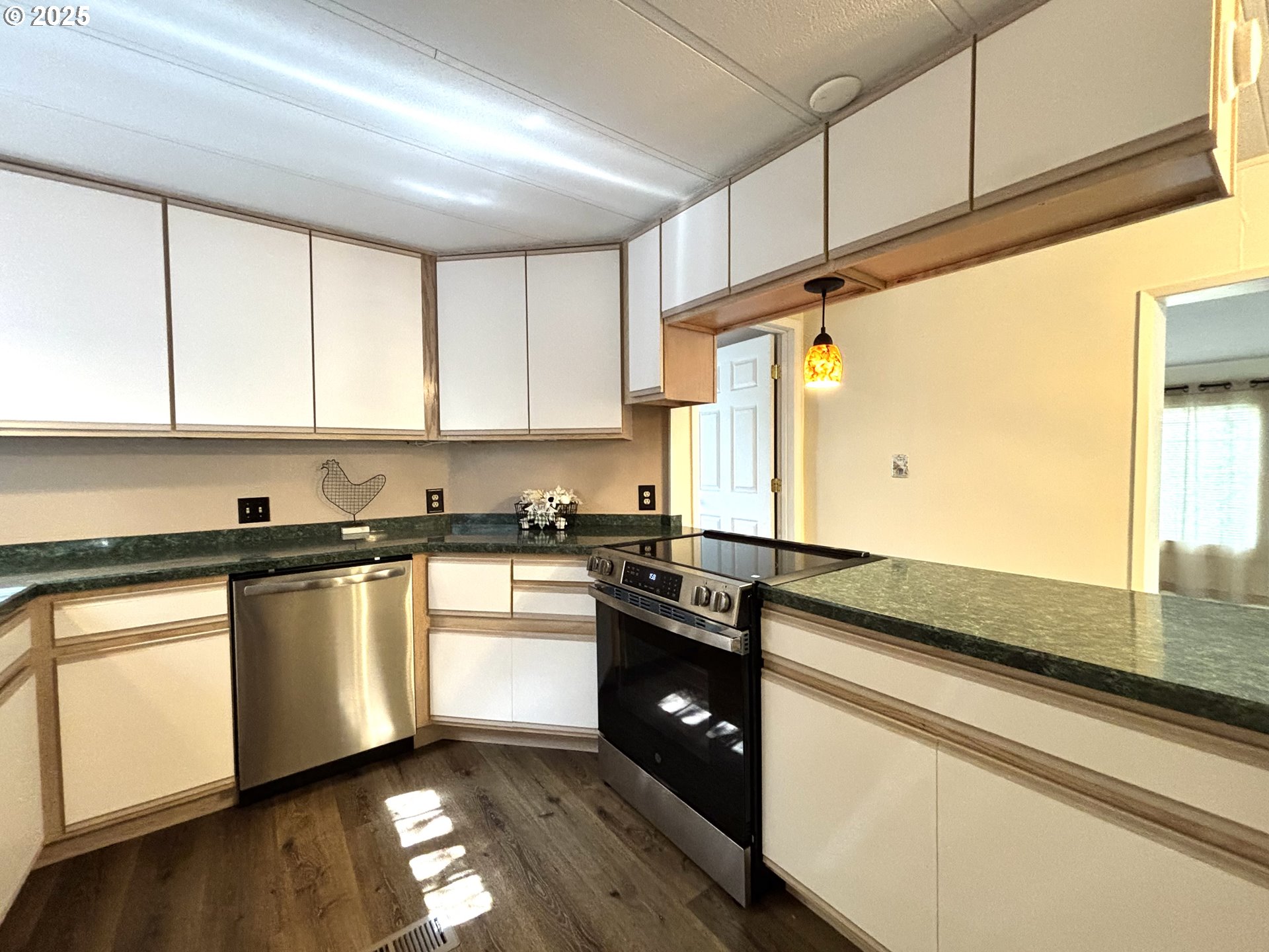 1600 Rhododendron Drive, Unit 29 Florence, OR 97439 - Photo 15 of 35 a kitchen with granite countertop stainless steel appliances a sink window and cabinets