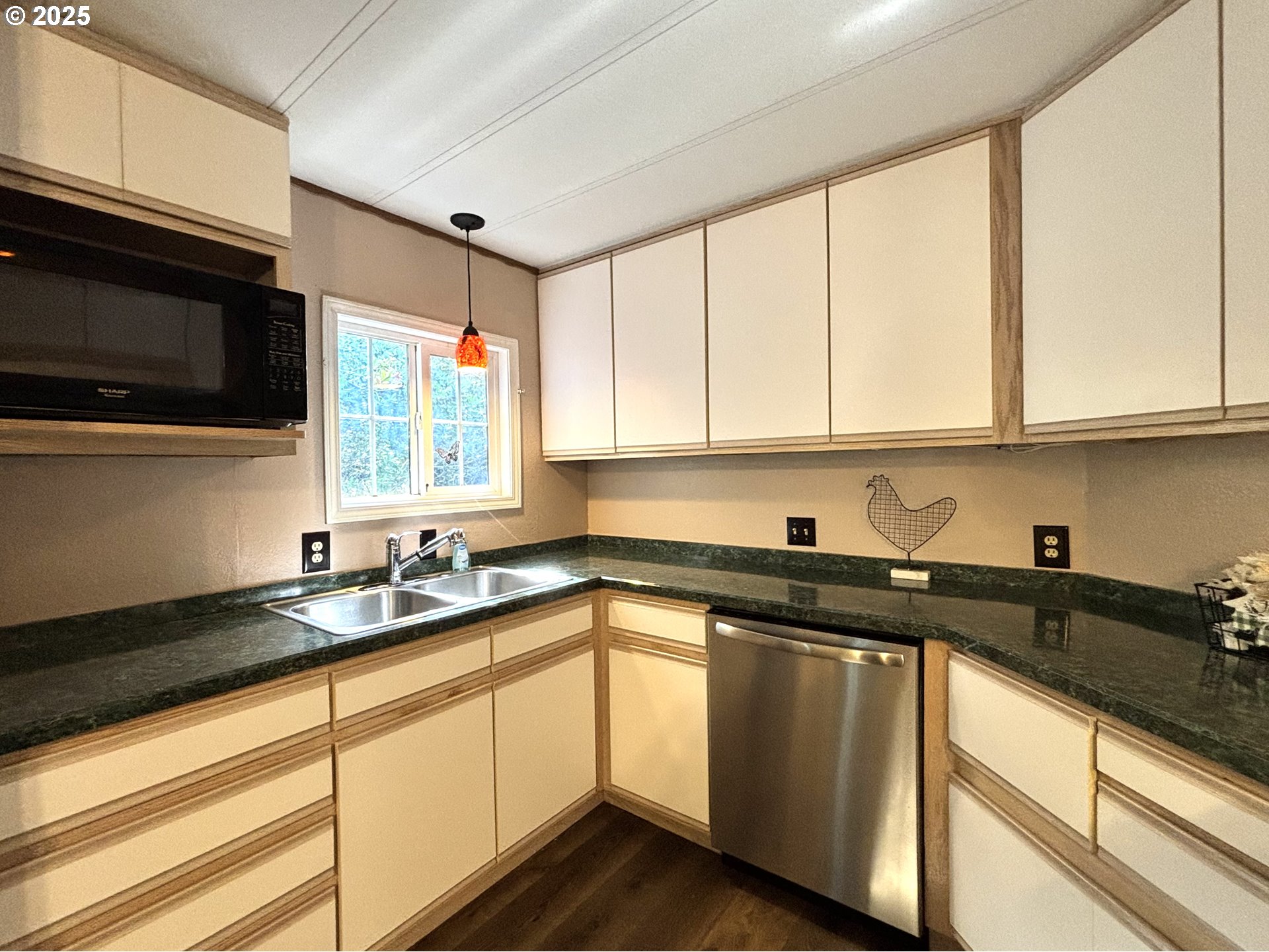1600 Rhododendron Drive, Unit 29 Florence, OR 97439 - Photo 16 of 35 a kitchen with stainless steel appliances granite countertop white cabinets sink and a granite counter top