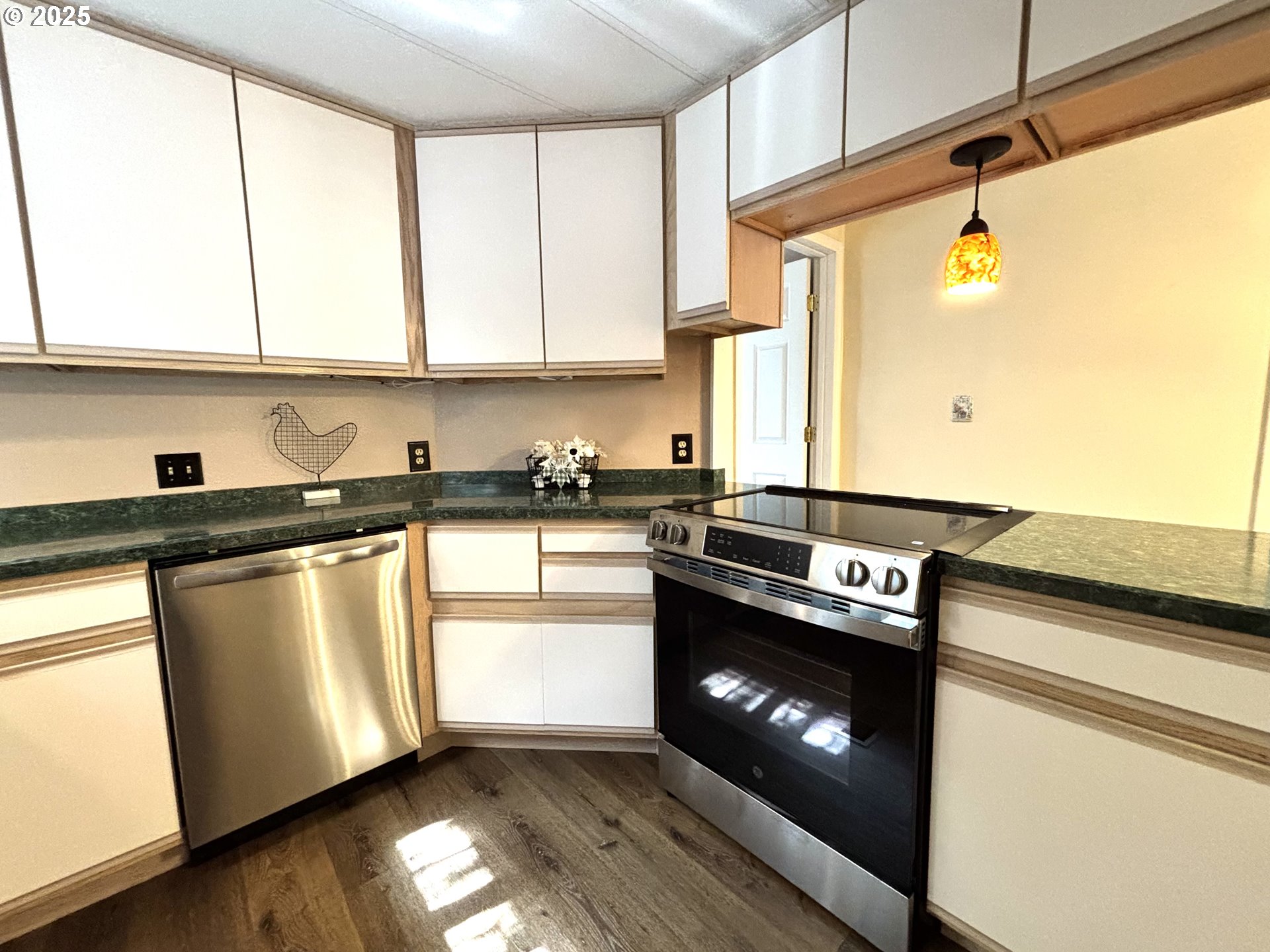 1600 Rhododendron Drive, Unit 29 Florence, OR 97439 - Photo 17 of 35 a kitchen with stainless steel appliances granite countertop a stove a sink and a microwave