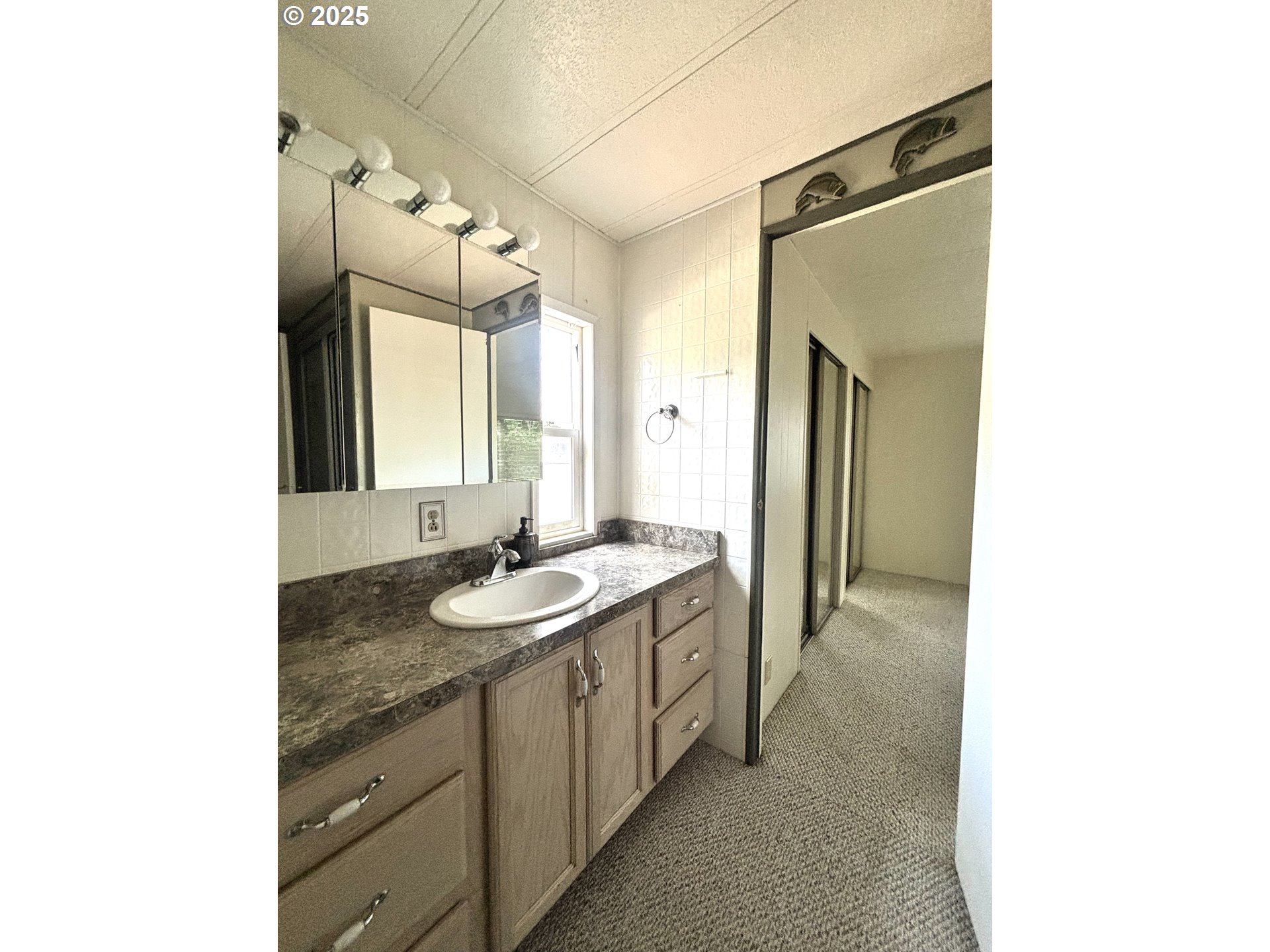 1600 Rhododendron Drive, Unit 29 Florence, OR 97439 - Photo 27 of 35 a bathroom with a granite countertop sink and a mirror