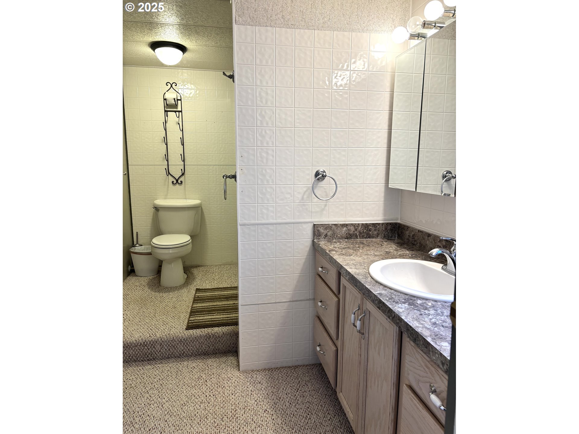 1600 Rhododendron Drive, Unit 29 Florence, OR 97439 - Photo 28 of 35 a spacious bathroom with a granite countertop sink and a mirror