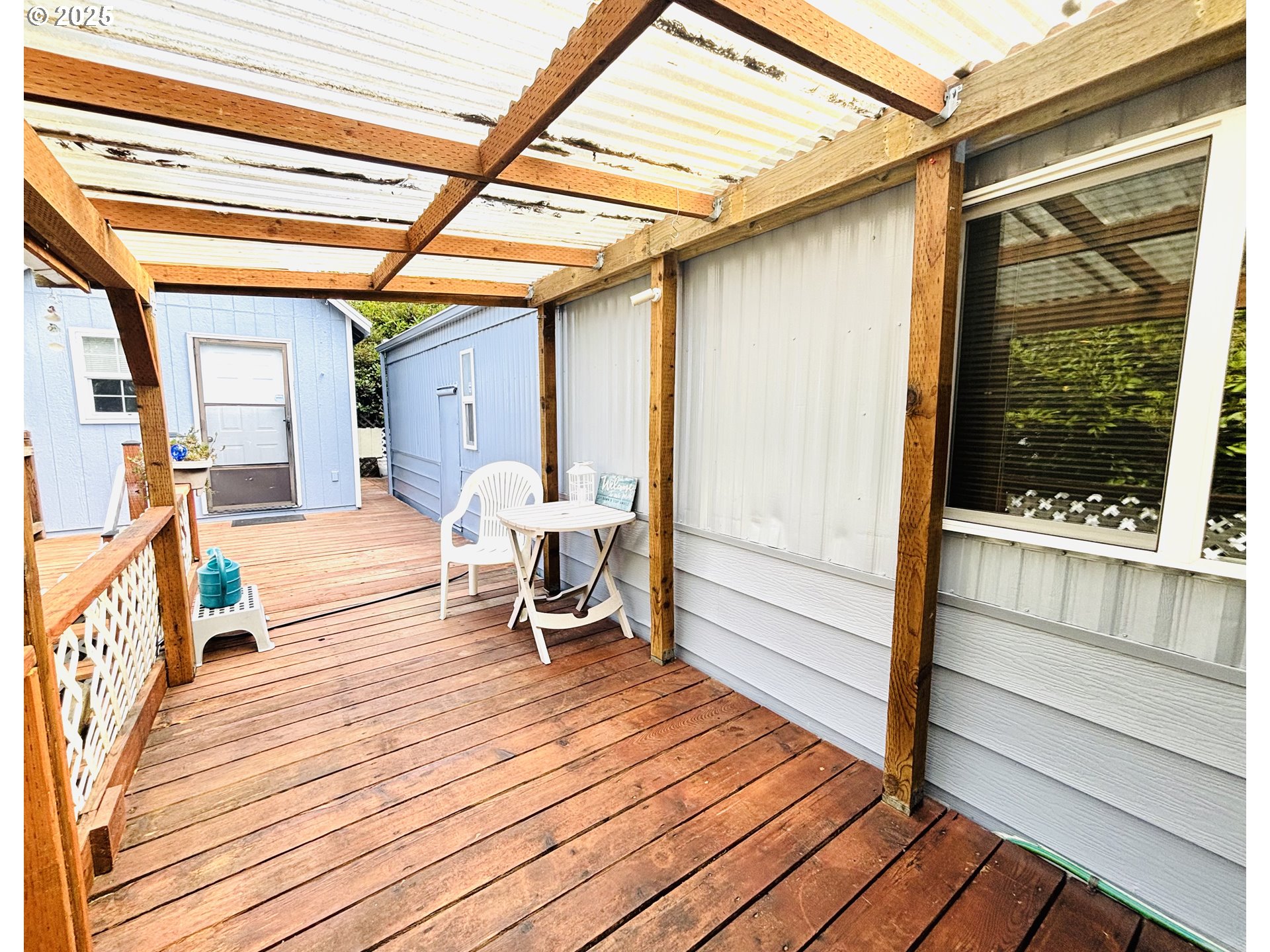 1600 Rhododendron Drive, Unit 29 Florence, OR 97439 - Photo 33 of 35 a bedroom with wooden floor and furniture