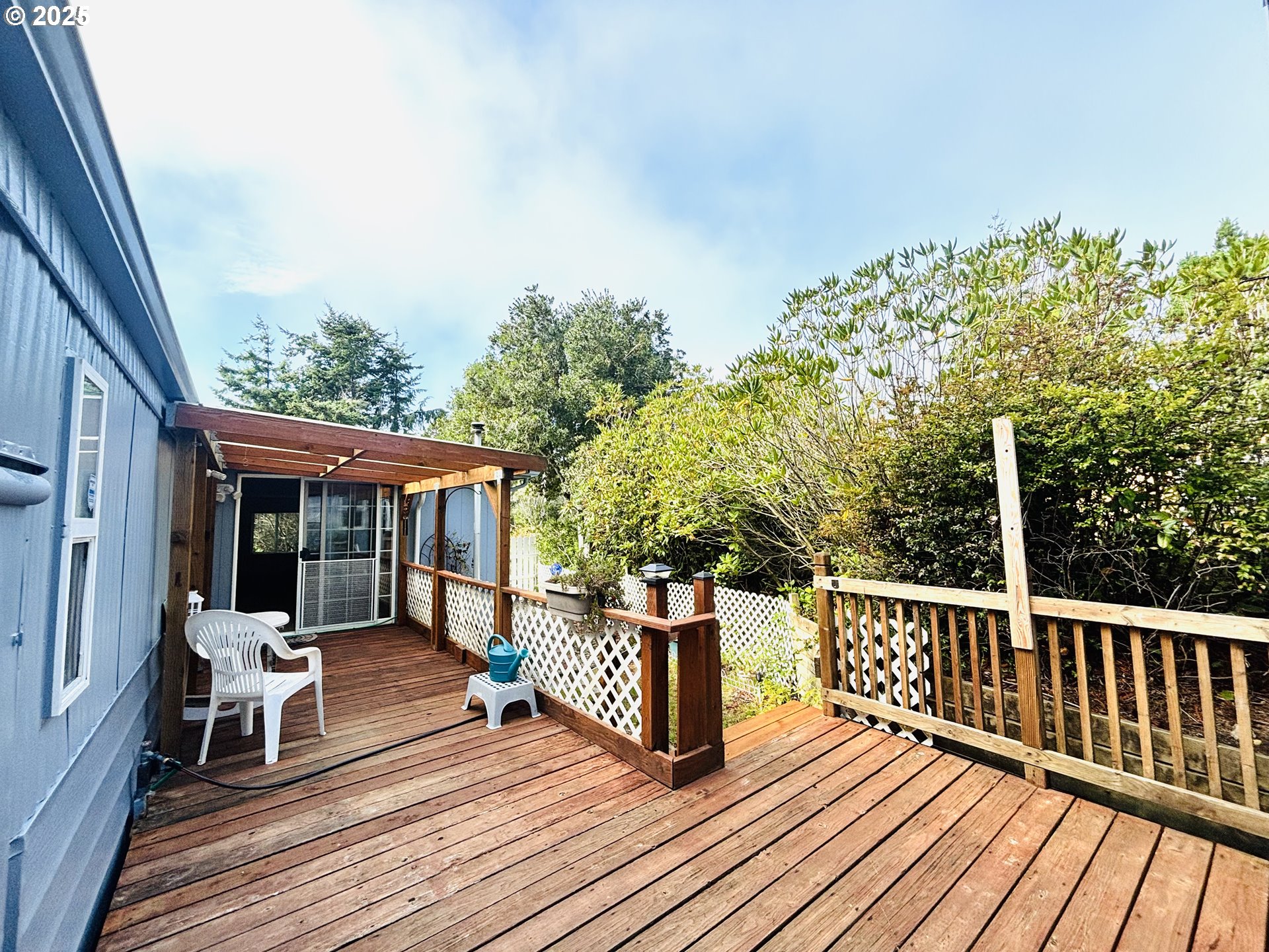1600 Rhododendron Drive, Unit 29 Florence, OR 97439 - Photo 34 of 35 a view of a wooden deck and a yard