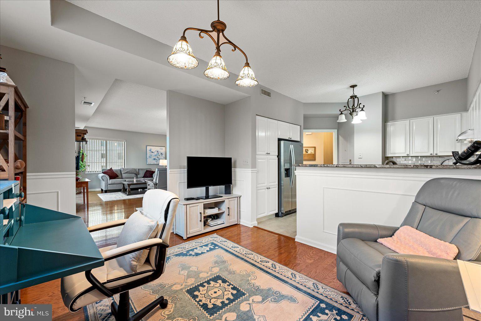 19375 Cypress Ridge Terrace, Unit 207 Leesburg, VA 20176 - Photo 11 of 44 a view of a dining room with furniture and wooden floor