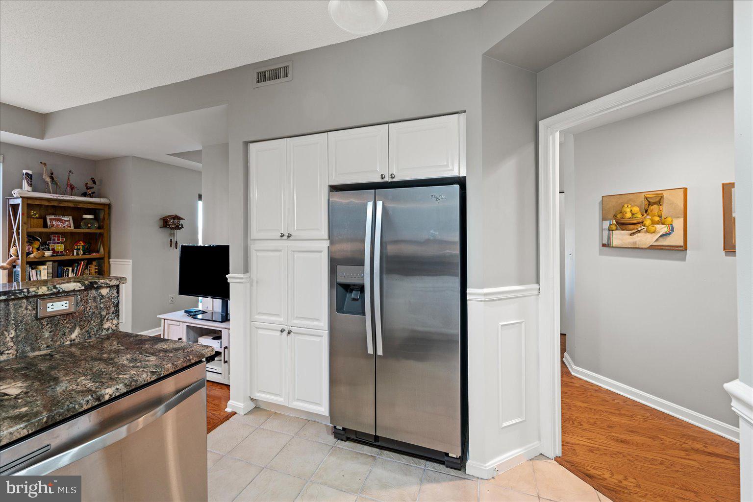 19375 Cypress Ridge Terrace, Unit 207 Leesburg, VA 20176 - Photo 15 of 44 a kitchen with stainless steel appliances granite countertop a refrigerator and a stove