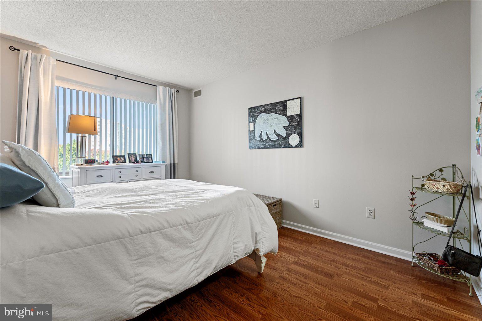 19375 Cypress Ridge Terrace, Unit 207 Leesburg, VA 20176 - Photo 17 of 44 a bedroom with a bed and a window