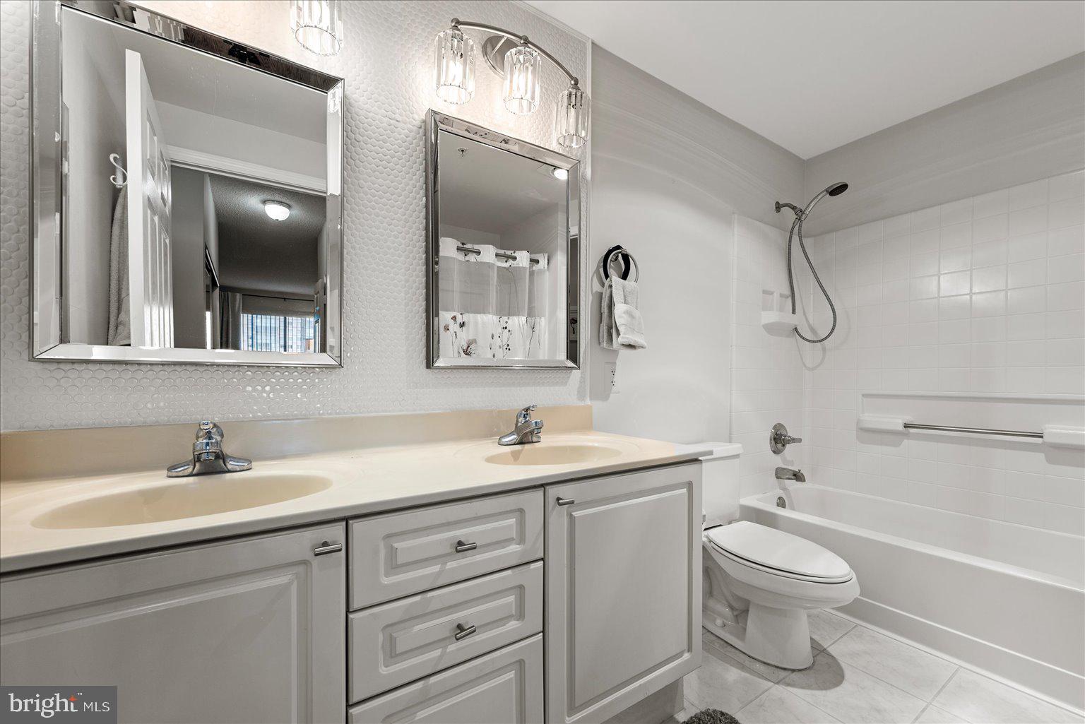 19375 Cypress Ridge Terrace, Unit 207 Leesburg, VA 20176 - Photo 18 of 44 a bathroom with a toilet sink and mirror