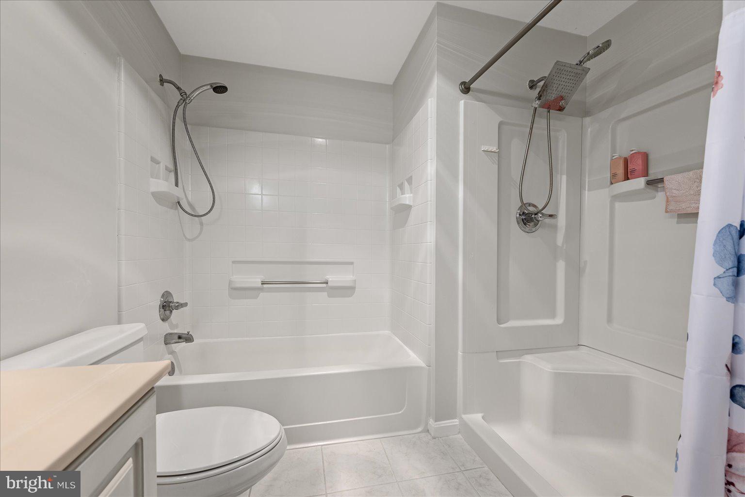 19375 Cypress Ridge Terrace, Unit 207 Leesburg, VA 20176 - Photo 19 of 44 a bathroom with a toilet bathtub and shower