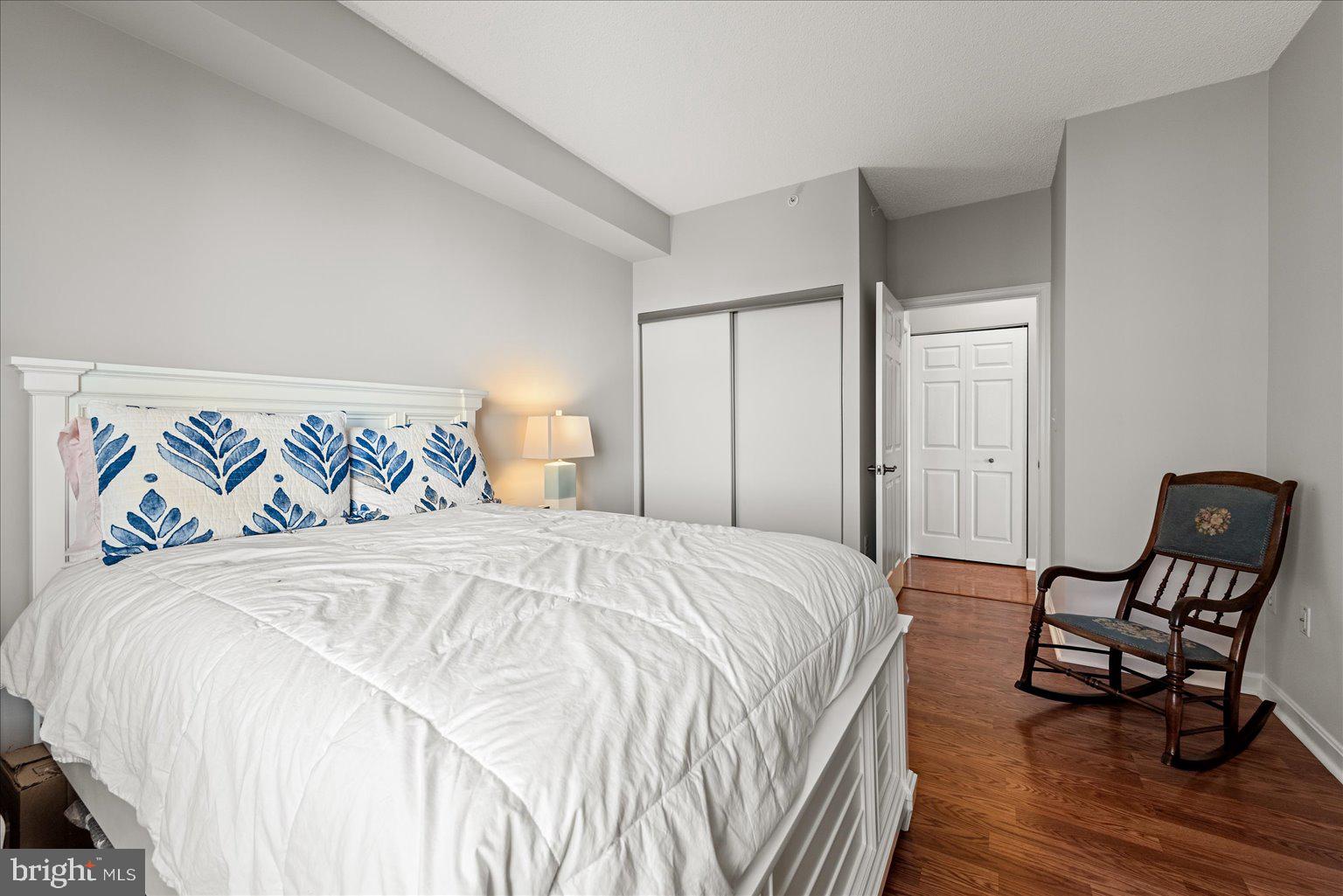 19375 Cypress Ridge Terrace, Unit 207 Leesburg, VA 20176 - Photo 21 of 44 a bedroom with a bed and wooden floor