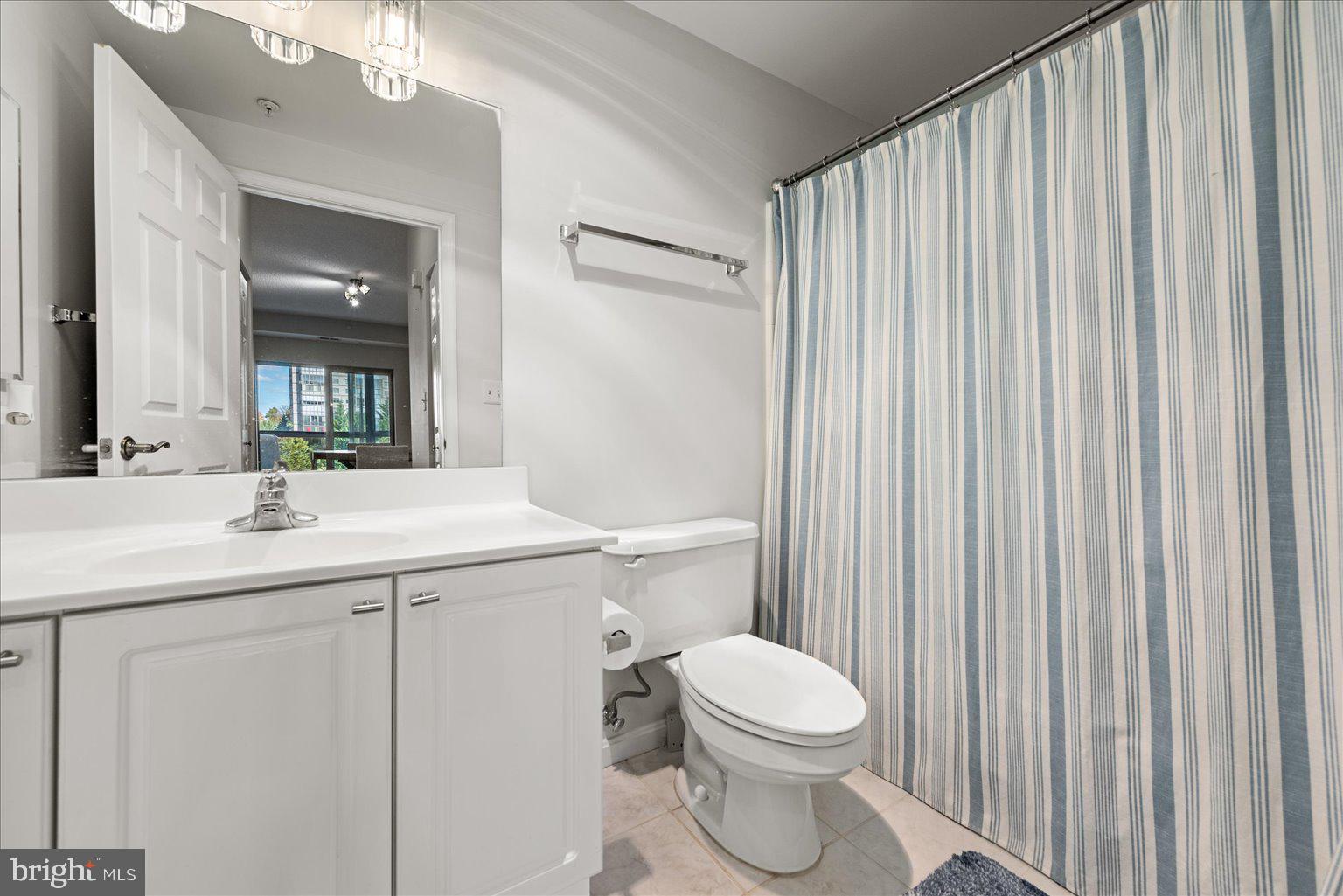 19375 Cypress Ridge Terrace, Unit 207 Leesburg, VA 20176 - Photo 22 of 44 a bathroom with a sink a toilet and shower