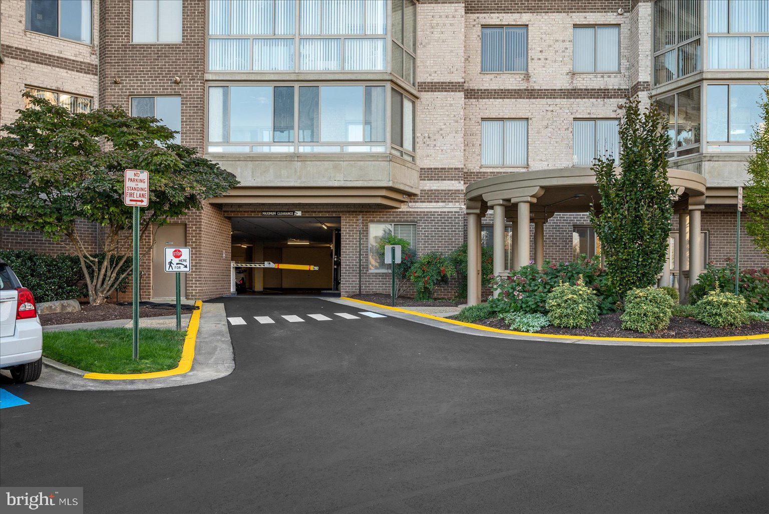 19375 Cypress Ridge Terrace, Unit 207 Leesburg, VA 20176 - Photo 31 of 44 a front view of a building with garden