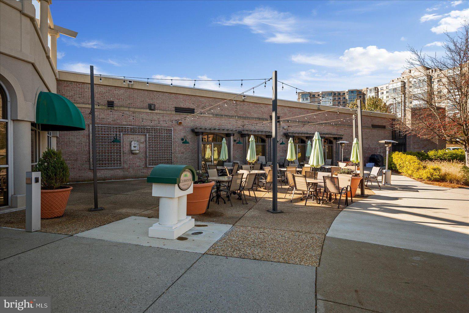 19375 Cypress Ridge Terrace, Unit 207 Leesburg, VA 20176 - Photo 39 of 44 a view of a patio with table and chairs potted plants