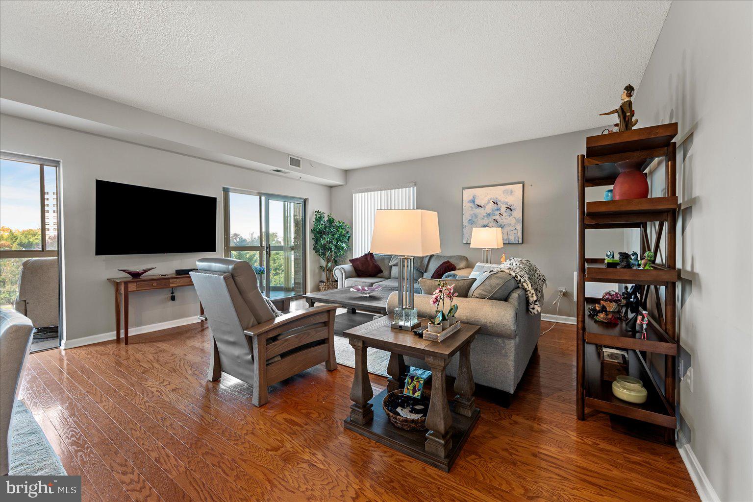 19375 Cypress Ridge Terrace, Unit 207 Leesburg, VA 20176 - Photo 4 of 44 a living room with furniture and a flat screen tv