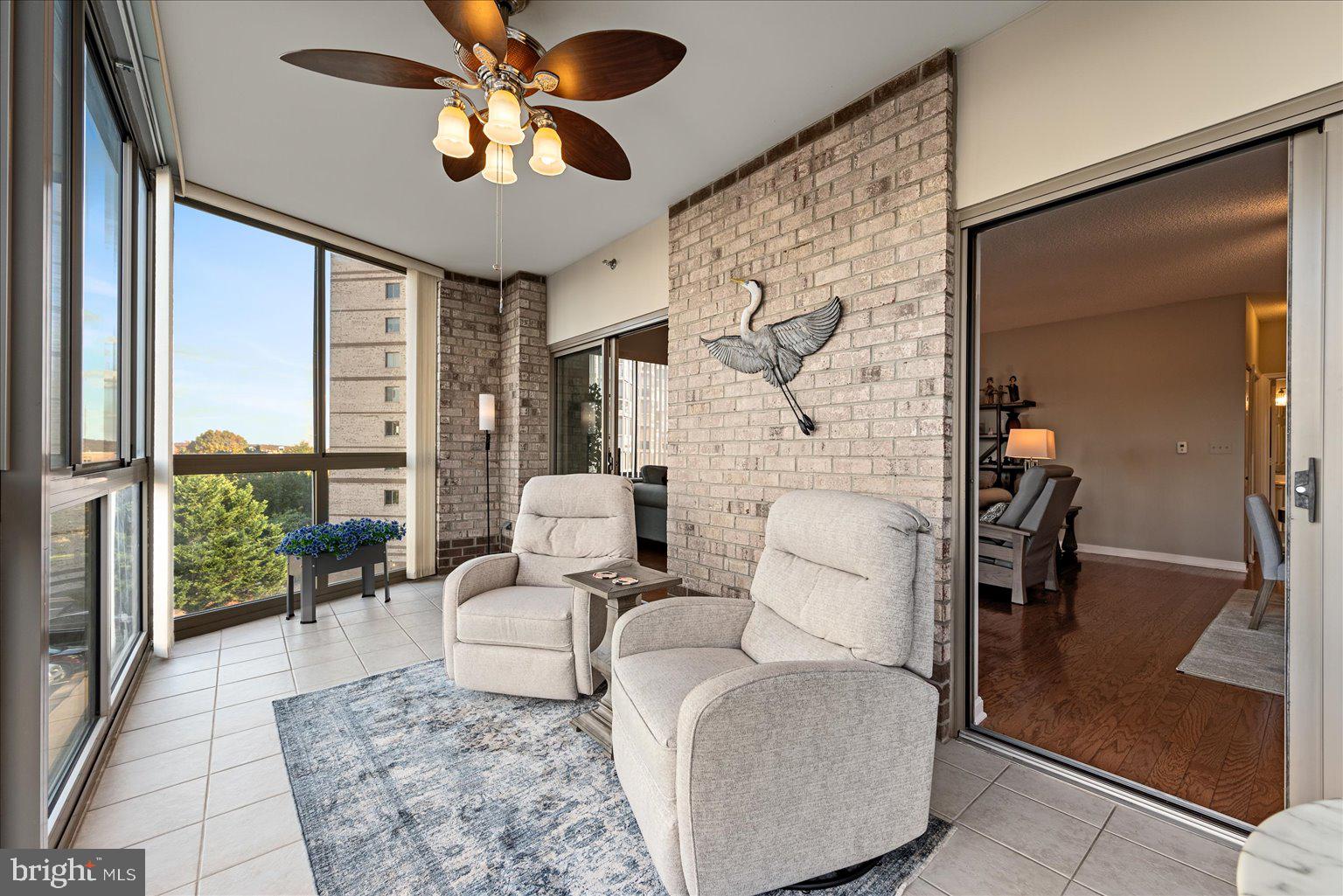 19375 Cypress Ridge Terrace, Unit 207 Leesburg, VA 20176 - Photo 7 of 44 a living room with furniture and a large window