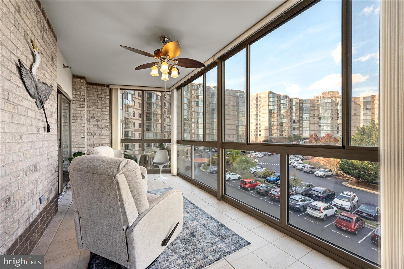 19375 Cypress Ridge Terrace, Unit 207 Leesburg, VA 20176 - Photo 8 of 44 a living room with furniture and a floor to ceiling window
