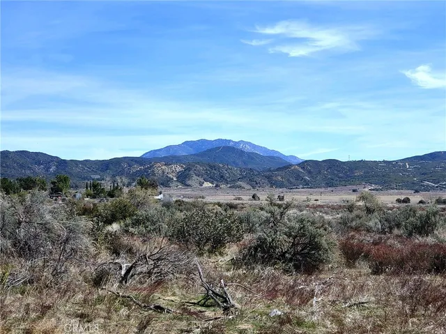 a view of a and mountain in a field