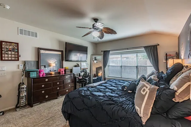 a bedroom with a bed and a flat tv screen