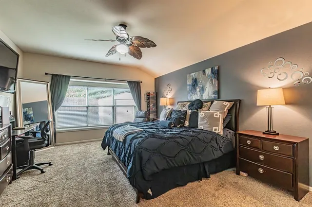 a bedroom with bed and a chandelier