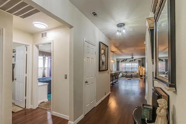 a view of a hallway view with living room and wooden floor