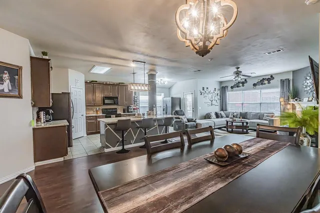 a living room with lots of furniture and kitchen view
