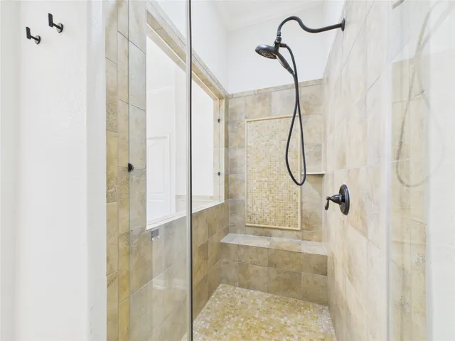 a bathroom with a glass shower door