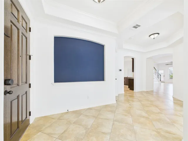 a view of a livingroom with wooden floor and a kitchen space