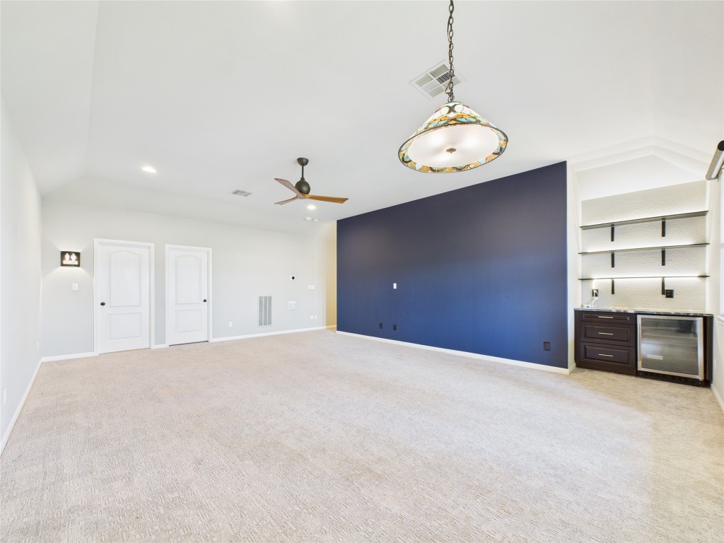 2624 Outlook Ridge Loop Leander, TX 78641 - Photo 33 of 39 a view of a kitchen with a chandelier wooden floor and stainless steel appliances