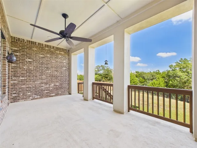a view of a porch with wooden floor and a floor to ceiling window