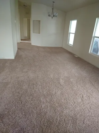 an empty room with windows and entrance
