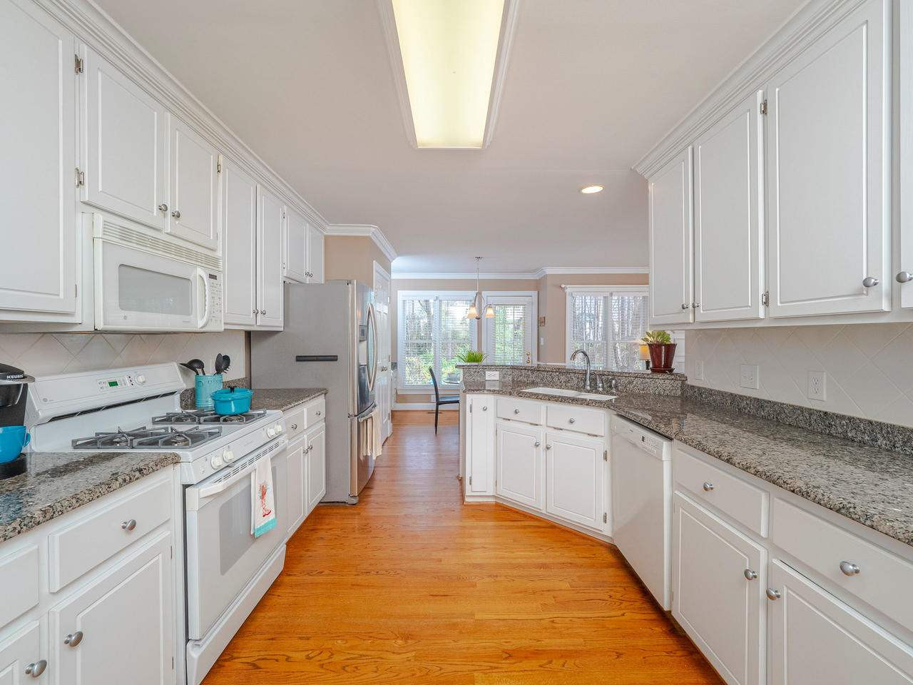 2904 Dahlgreen Road Raleigh, NC 27615 - Photo 7 of 30 White cabinets with granite and tile backsplash