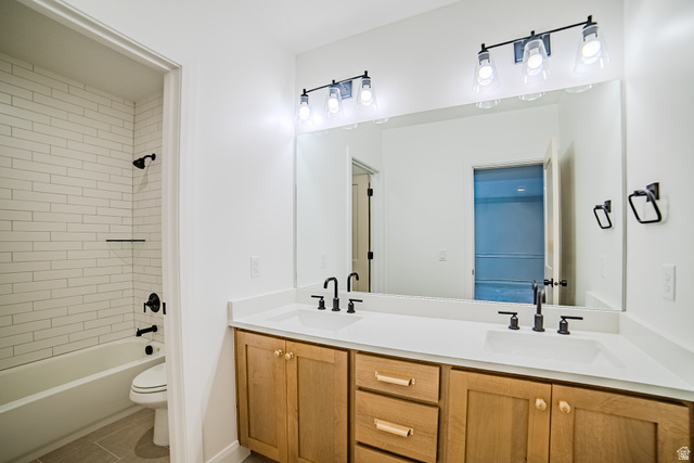 223 South Cottonwood Road, Unit 7501 Vineyard, UT 84059 - Photo 11 of 45 Dual vanity with light wood cabinetry, white countertops, and matte black fixtures
