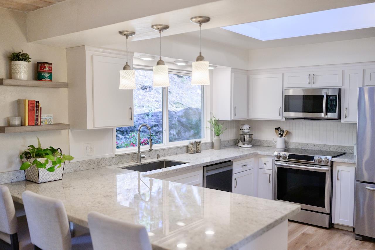 155 Rabbits Run Road Santa Cruz, CA 95060 - Photo 7 of 113 a kitchen with stainless steel appliances a sink a stove a microwave a dining table and chairs