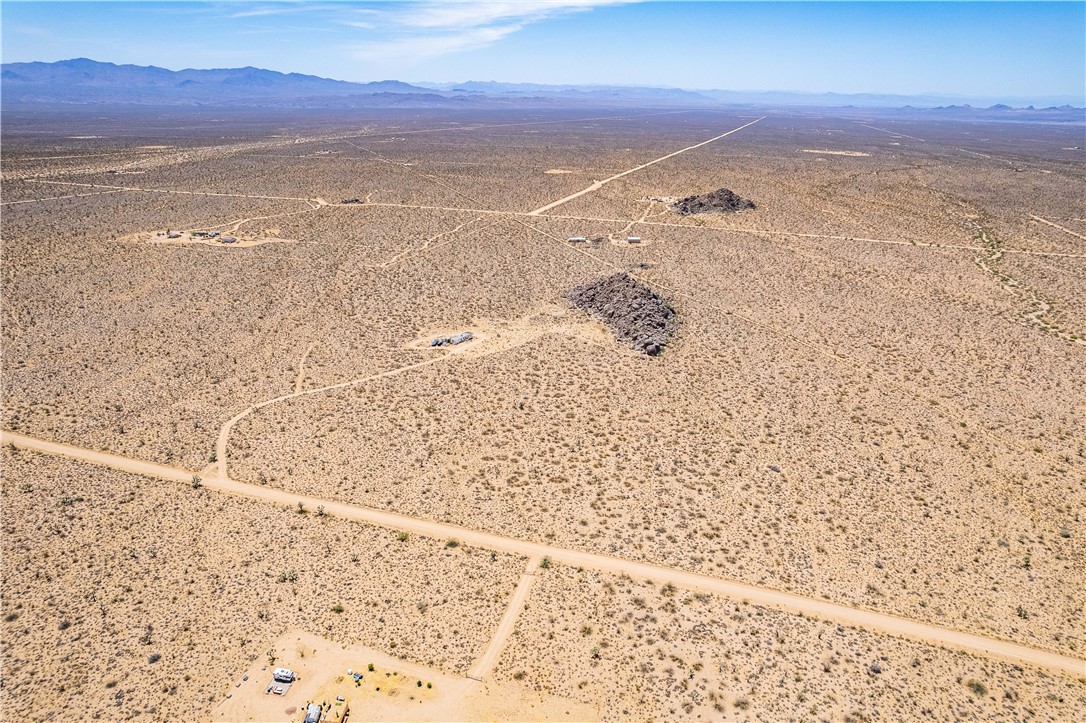 16435 South Wyatt Earp Road Yucca, AZ 86438 - Photo 49 of 57 Expansive desert landscape featuring natural rock formations and distant mountain ranges
