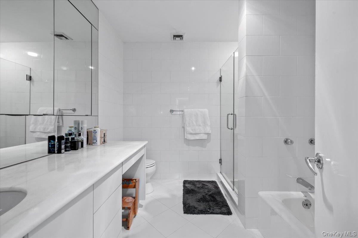 90 Rodeo Drive Syosset, NY 11791 - Photo 12 of 18 a bathroom with a sink vanity granite tub shower and mirror