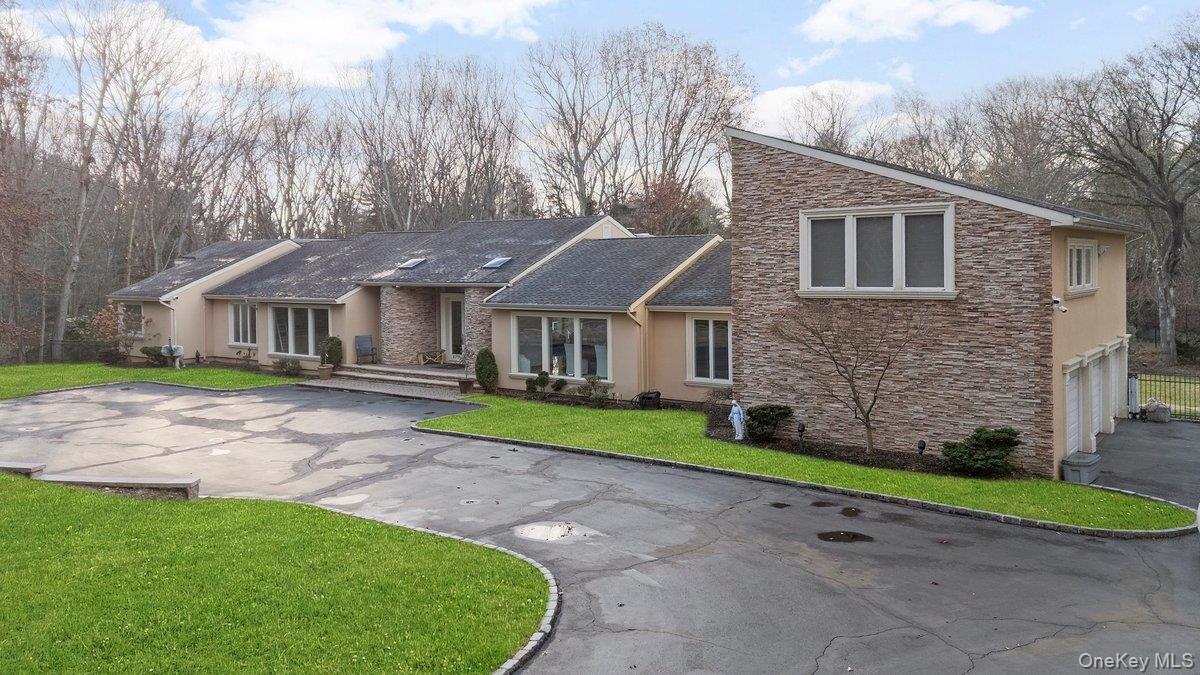 90 Rodeo Drive Syosset, NY 11791 - Photo 15 of 18 a view of house with a garden and pathway