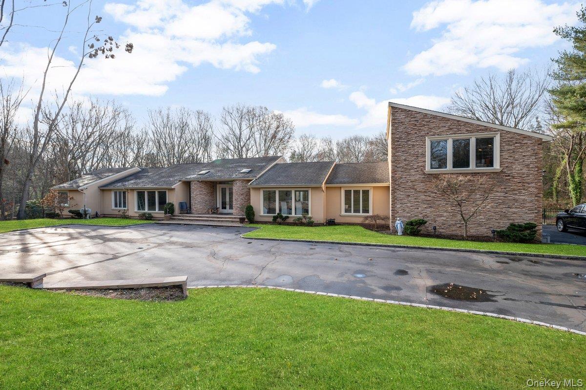 90 Rodeo Drive Syosset, NY 11791 - Photo 16 of 18 a front view of a house with a yard