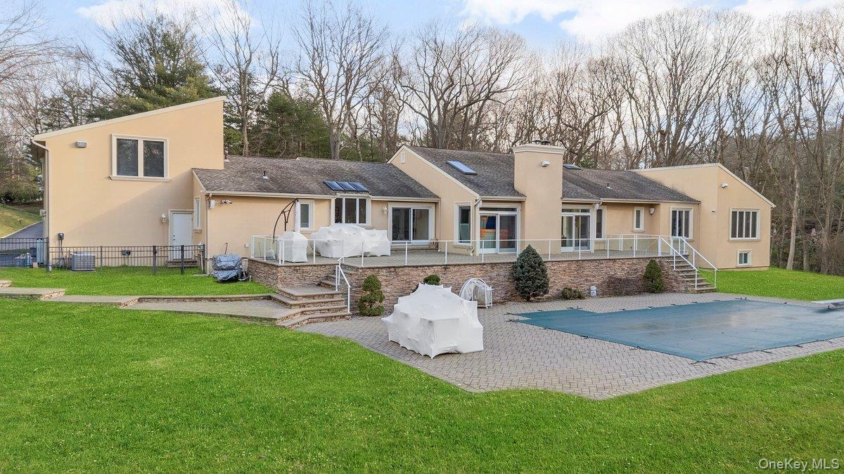 90 Rodeo Drive Syosset, NY 11791 - Photo 17 of 18 a front view of a house with a garden and yard