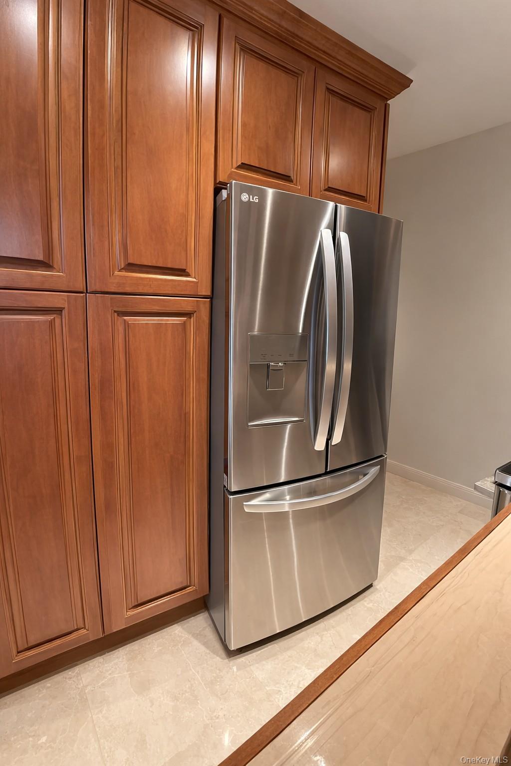 90 Rodeo Drive Syosset, NY 11791 - Photo 9 of 18 a metallic refrigerator freezer sitting in a kitchen