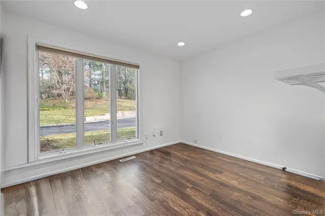 a view of wooden floor and windows in a room