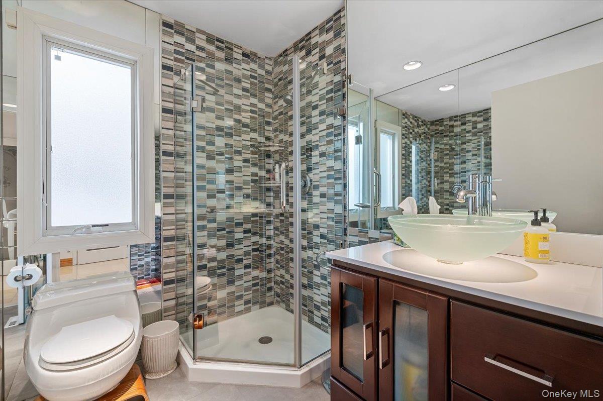 90 Rodeo Drive Syosset, NY 11791 - Photo 10 of 18 a bathroom with a sink a toilet and shower